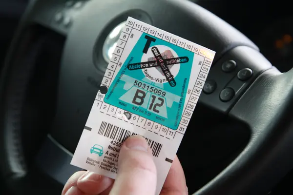 Mensch hält Vignette für Österreichische Autobahn in der Hand