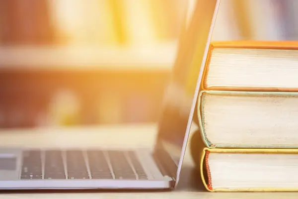 Bücher und Computer vor hellem Licht