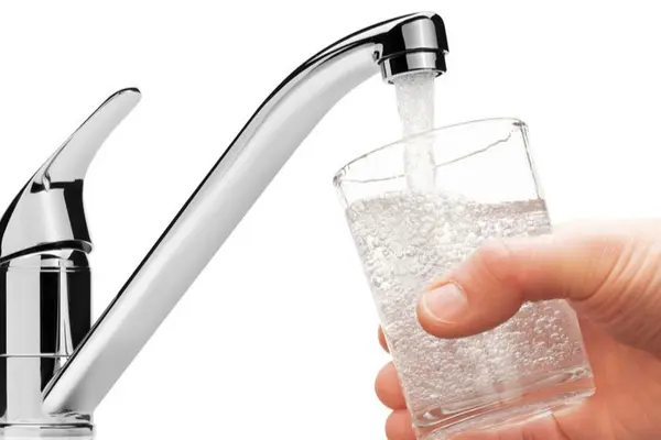 Wasserhahn mit einen Glas Wasser