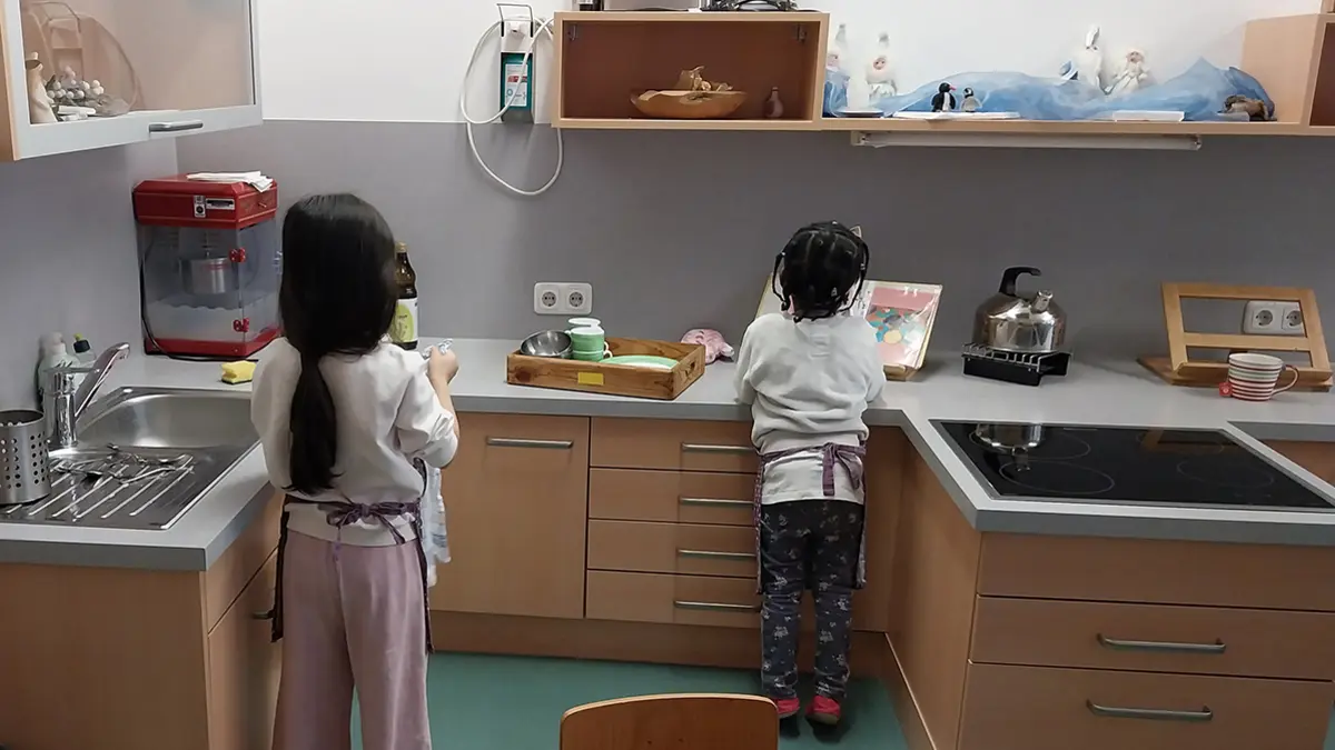 Bild einer Küche mit Herd, Spüle, Arbeitsfläche und Ofen auf Kinderhöhe