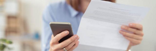 Frau mit Smartphone und Vertrag