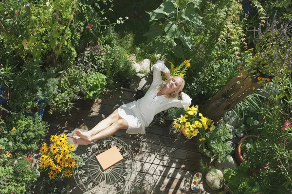 Eine Frau genießt ihren grünen Garten.