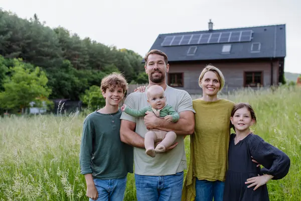 Eine Familie vor einem Haus auf dem Land