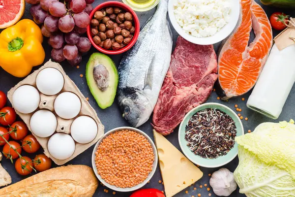 ein voll gedeckter Tisch mit vielen verschiedenen Lebensmitteln, darunter Eier, Avocado und Fisch