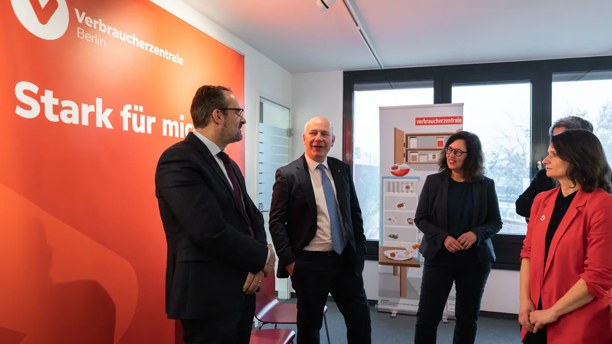 Markus Kamrad, Kai Wegner, Petra Hegemann und Britta Schautz vor einem Roll-Up der Verbraucherzentrale