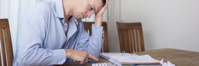 Verzweifelter Schuldner mit Unterlagen