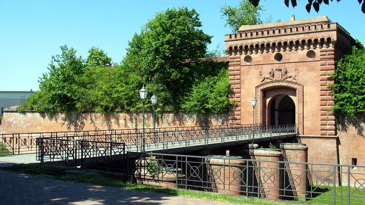 Ein Stadttor mit Brücke aus Stein.