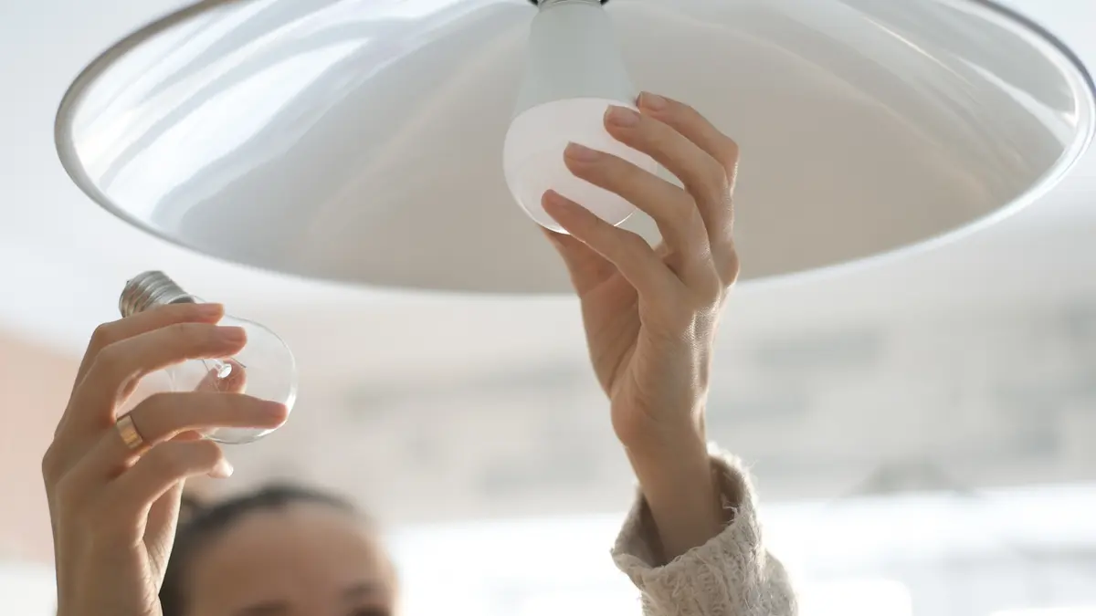 Frau tauscht Glühbirne durch Energiesparlampe aus