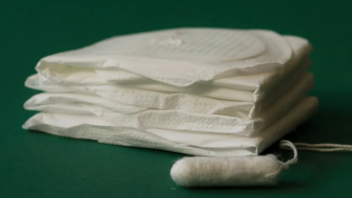 Binden und Tampons auf grünem Hintergrund.