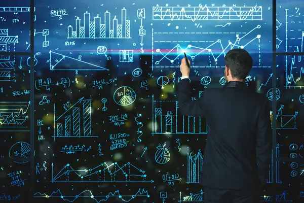 Ein mann steht vor einer Tafel mit vielen Statistiken und Diagrammen