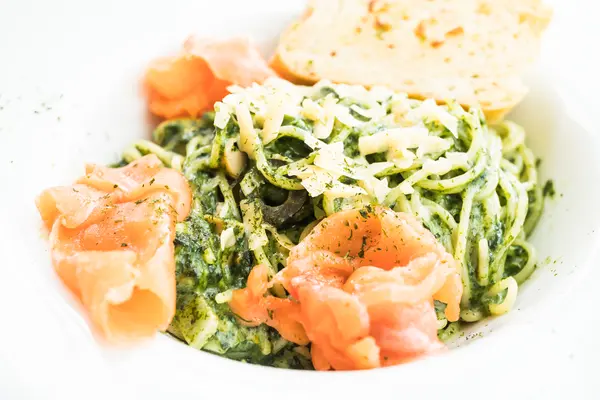 Eine Schüssel mit Nudeln, Pesto und Lachs