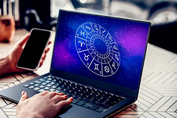 Nahaufnahme Horoskop auf Laptop und Smartphone in Hand
